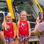 kids in front of a helicopter