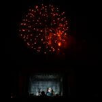 red fireworks above a stage