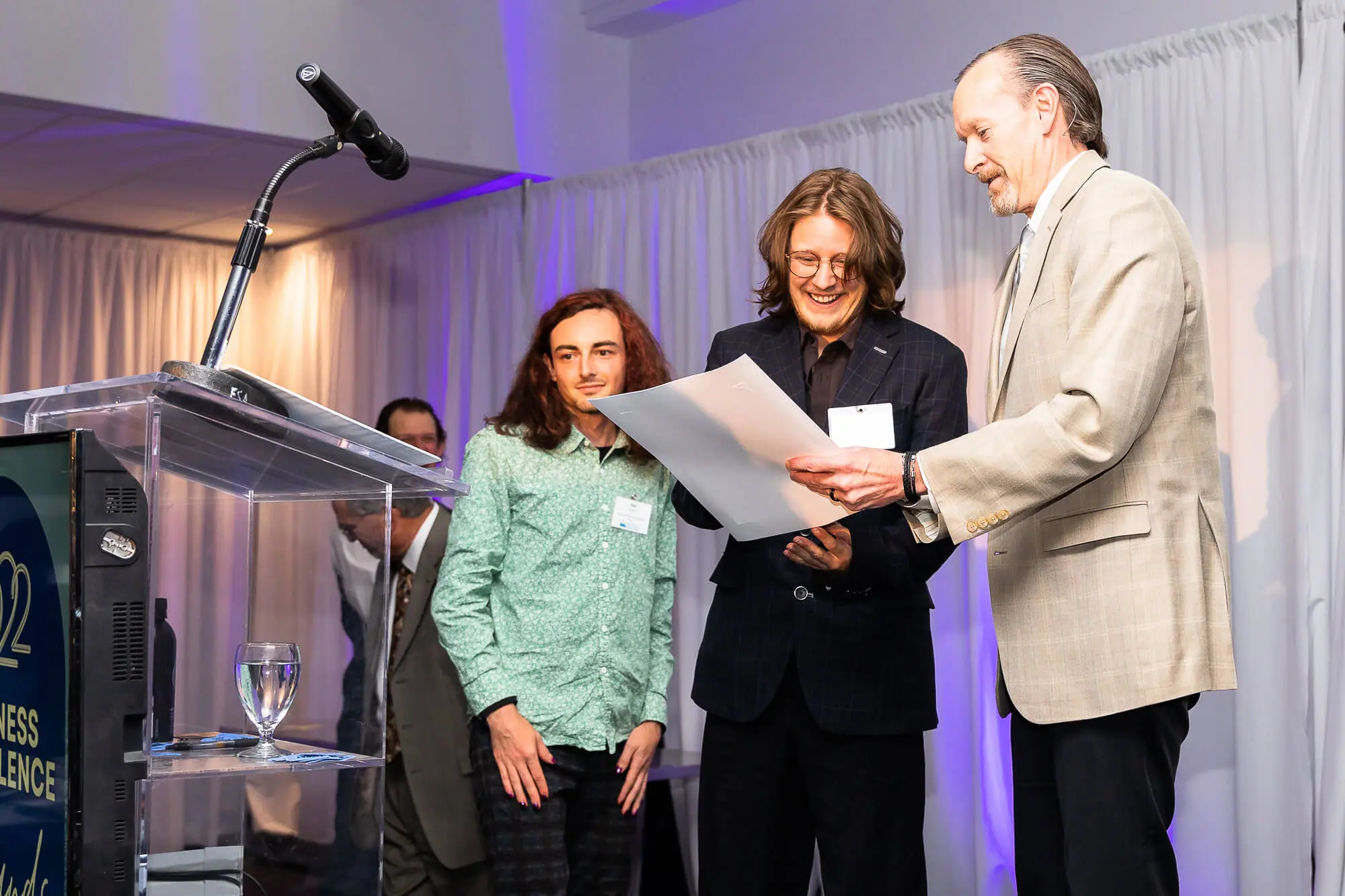 Mammoth Business Essentials owner and staff accept their award for Business of the Year with big smiles