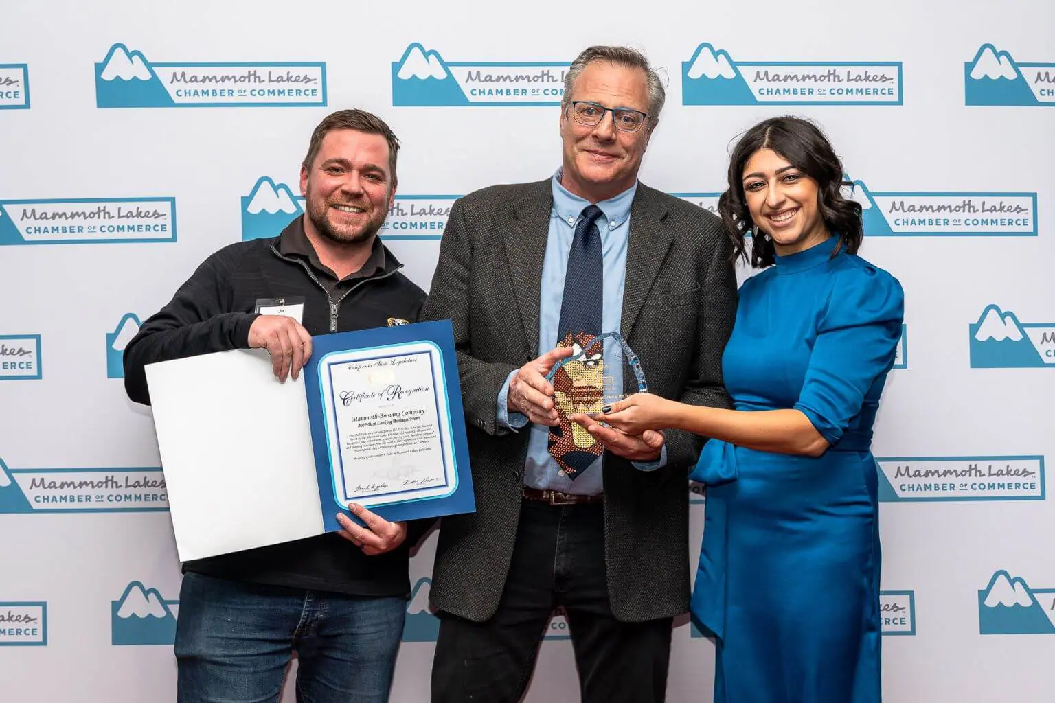 Mammoth Brewing Company staff pose with Chamber staff Brianna Goico and their award for Best Looking Business Front of the Year