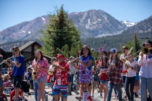 Mammoth schools band students play a variety of instruments while walking in the Mammoth Lakes 4th of July parade