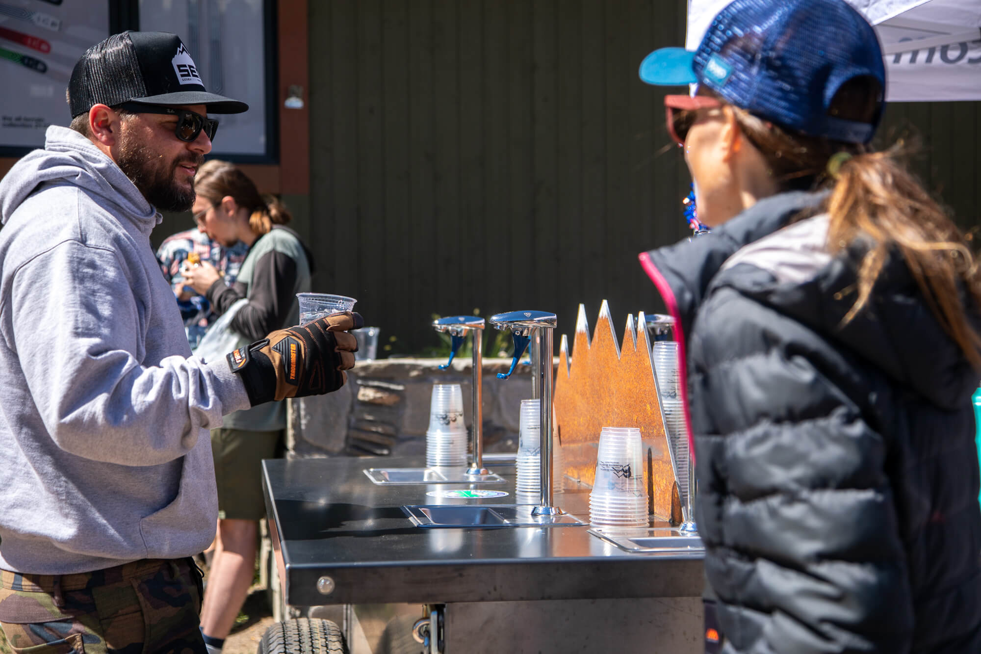 People chat at the hydration station at the Mammoth Lakes 4th of July parade