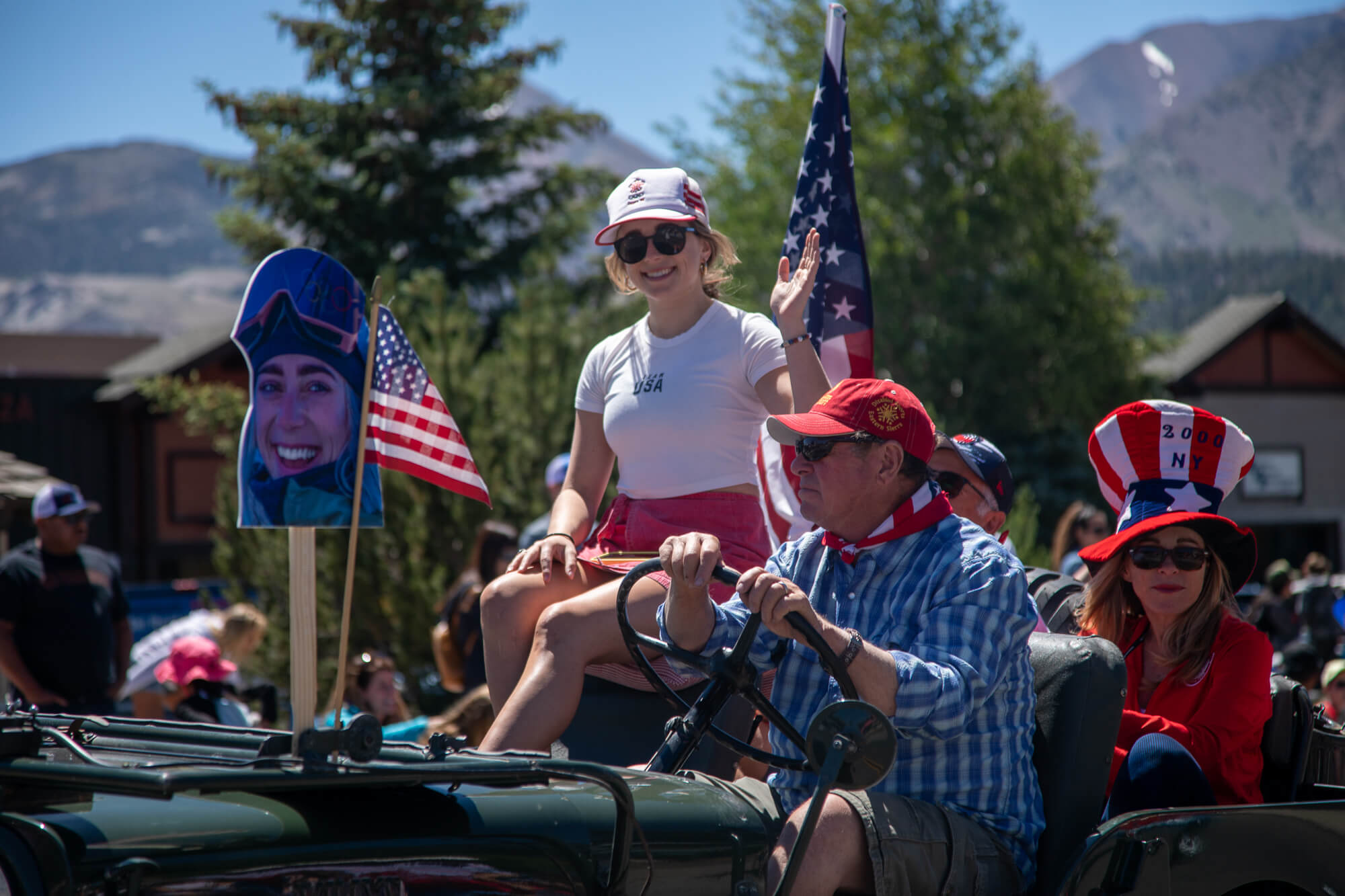 Grand marshal Carly Margulies waves while she's driven along the parade route in a vintage car