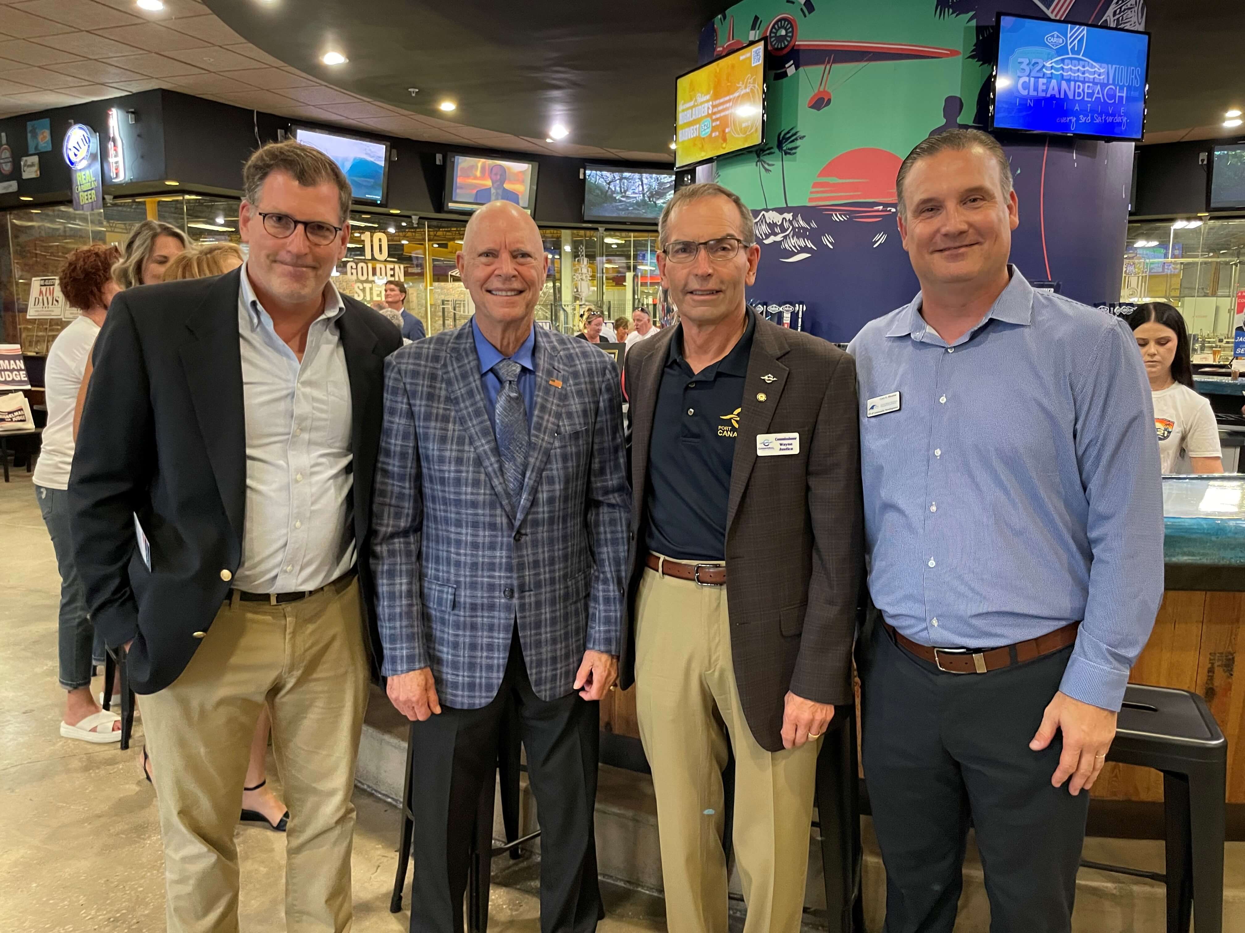 4 men standing and smiling