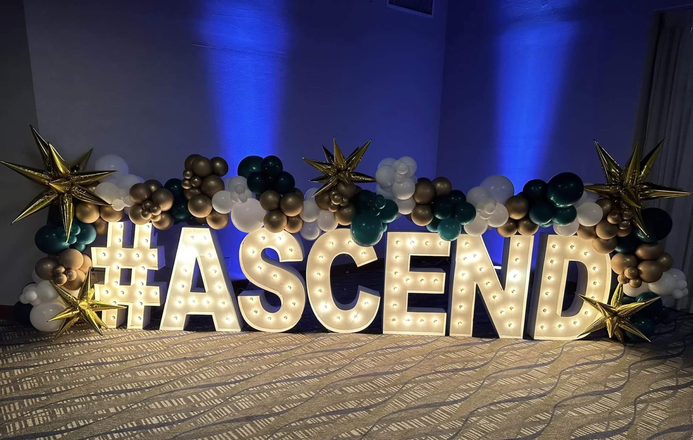 Ascend words lit up with balloons