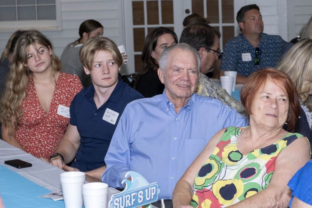 Doug Medlin in light blue shirt with his grand children and wife Cathy on right