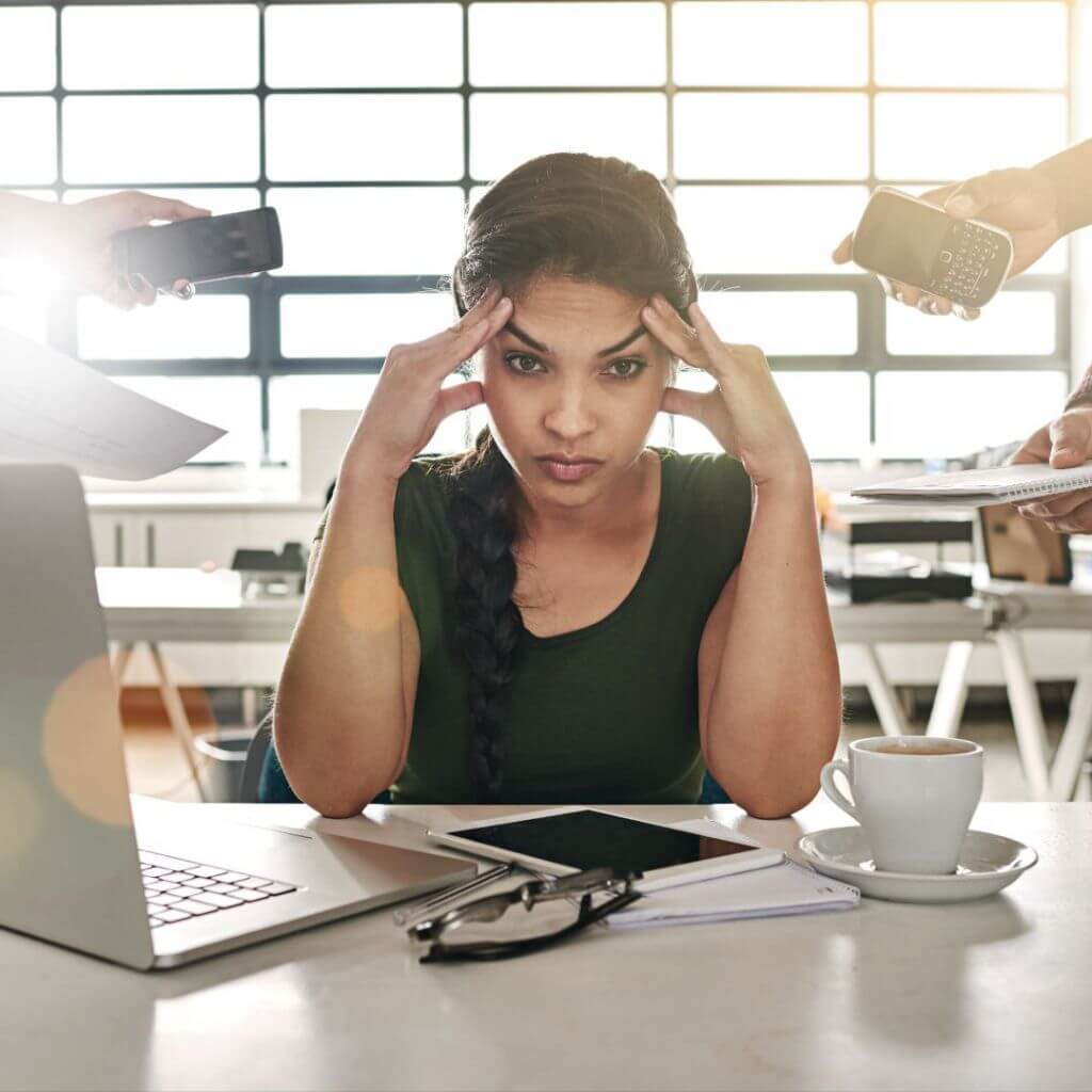 Employee overwhelmed at desk