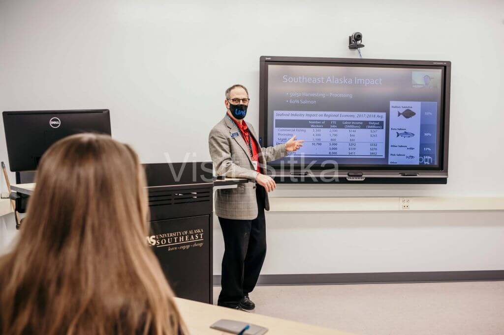 man presenting in front of a room
