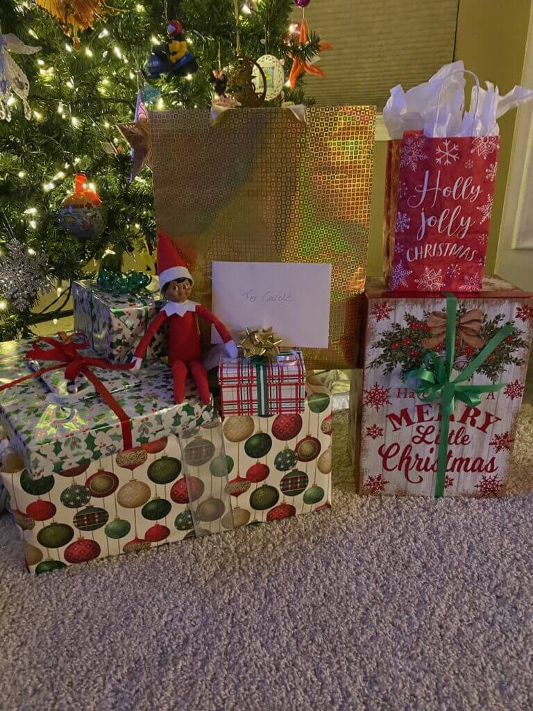 elf on the shelf sitting on presents