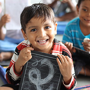 kid holding a chalkboard