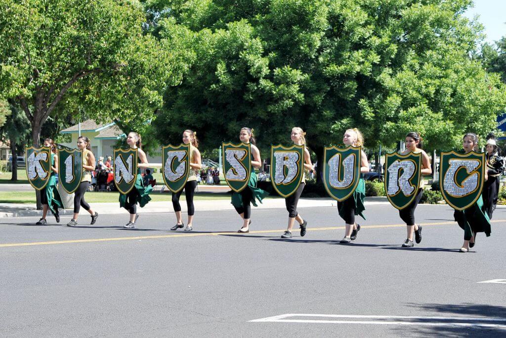 people with letter signs spelling out the name Kingsburg
