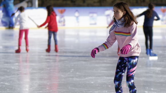 children skating on an outdoor rink