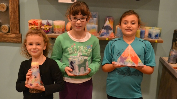 3 young girls holding homemade candles