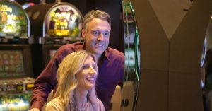 couple playing slot machine