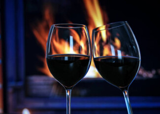 wine glasses in front of fireplace