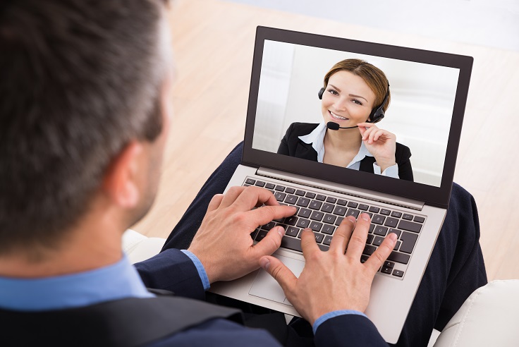 Businessman Video Chatting With Businesswoman On Laptop