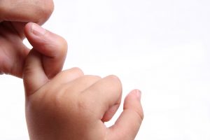 trust an adult and a child holding each other hook little finger.
in china, the meaning of this gesture is mutual trust and commitment.
