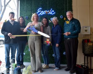 Robyn Miller cuts the ribbon as her business, Econic, is welcomed as a new member of the Logan County Chamber of Commerce Friday, April 21, 2023. Joining her are Elinor Brown, executive director of the Chamber, and Chamber board members and ambassadors Mike White, Jodie DiOrio, Micaela Ladd and Tim Edgar. (Callie Jones/Sterling Journal-Advocate)