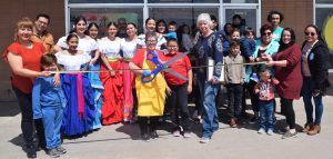 Sara Delgado cuts the ribbon welcoming her business, El Sabor de la Vida, as the newest Logan County Chamber of Commerce member Saturday, April 22, 2023. Joininger her are friends and family and Elinor Brown, executive director of the Chamber. El Sabor de la Vida started out as a food truck and now has a full restaurant located at 100 Broadway Street Suite 4, in Sterling. They serve a  variety of Mexican food including tacos, tordas, burritos and gorditas. (Callie Jones/Sterling Journal-Advocate)