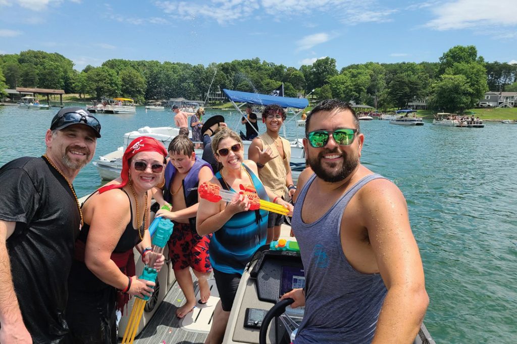 Jack St. Clair (far right) and his wife Jacqueline (red headband) enjoy Pirate Days with friends aboard their boat.