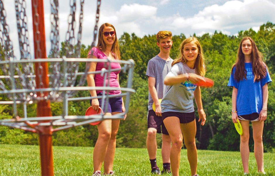 Teenagers playing disc golf in Bedford