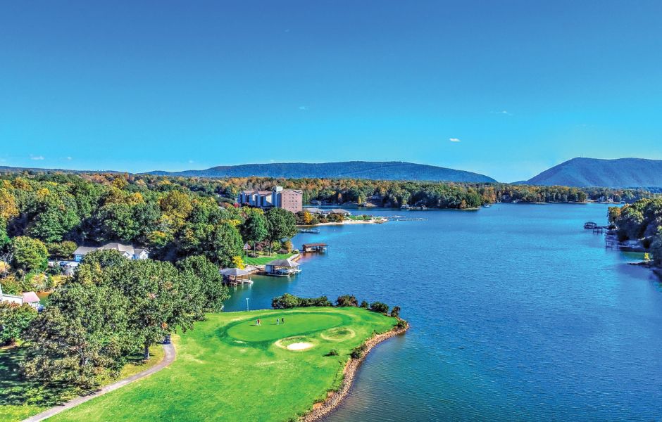 Aerial of golf hole at Mariners Landing with lake and mountain in the background.