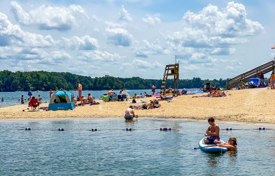Kids and adults playing on the beach at SML State Park
