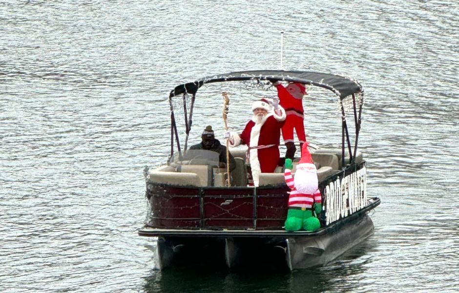 Santa waiving from a tritoon as he arrives at Bridgewater Plaza