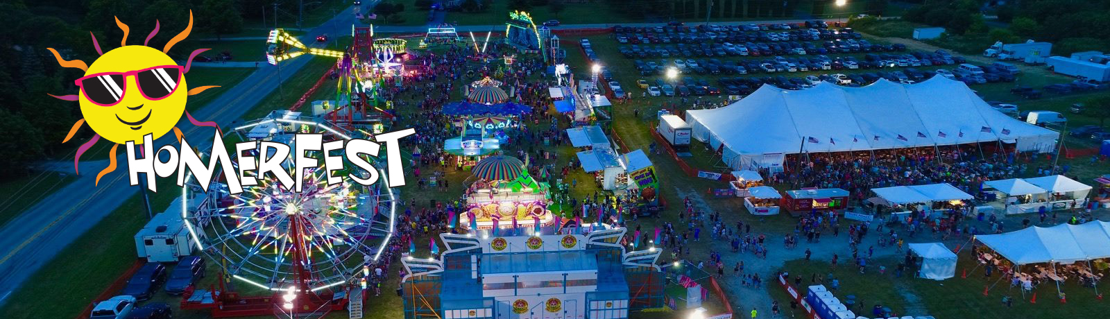 Drone photo of Homerfest at night with event logo in corner