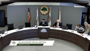 Trustees from Homer Glen sitting down after Pledge of Allegiance at 1-30-2023 meeting