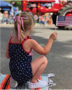 girl holding an american flag